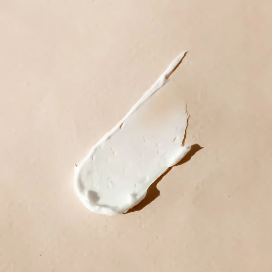 A palmful of moisturizer in soft afternoon light