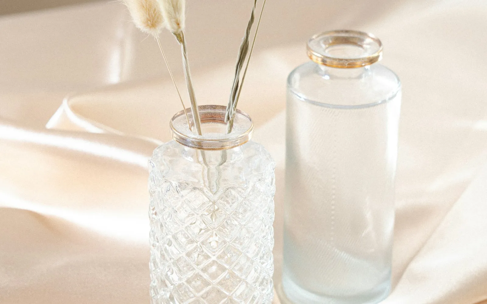 Lumo glass apothecary bottles and dried botanicals in soft studio light